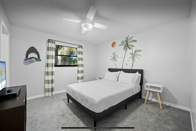 carpeted bedroom featuring ceiling fan, a textured ceiling, and baseboards