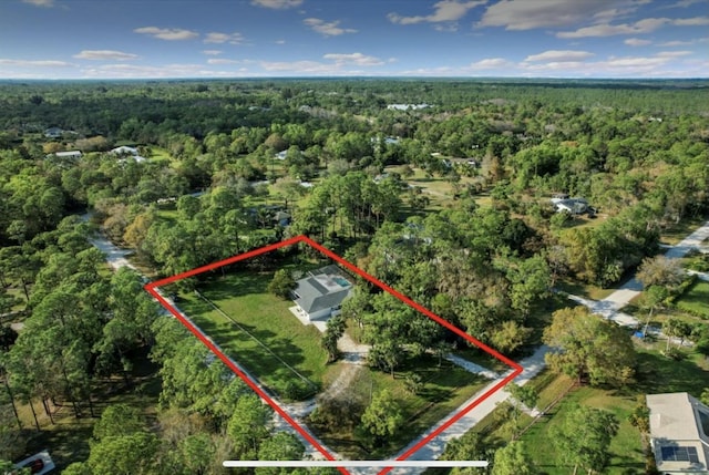 birds eye view of property with a wooded view