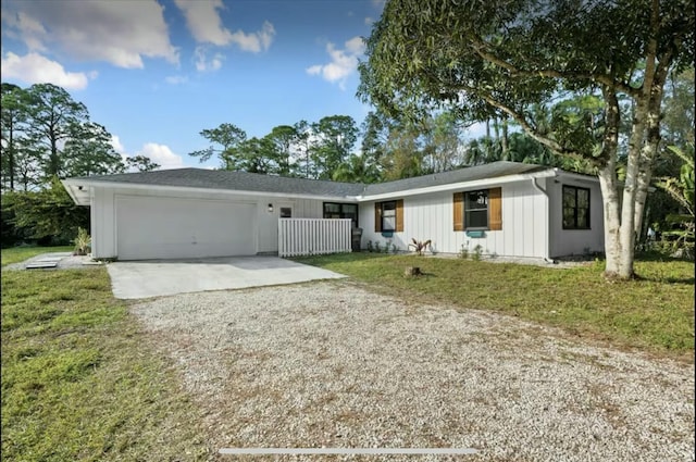 ranch-style house featuring a garage, concrete driveway, and a front lawn