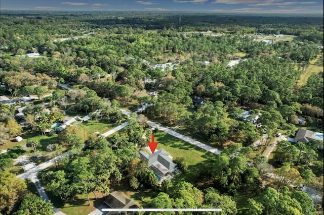 drone / aerial view featuring a forest view