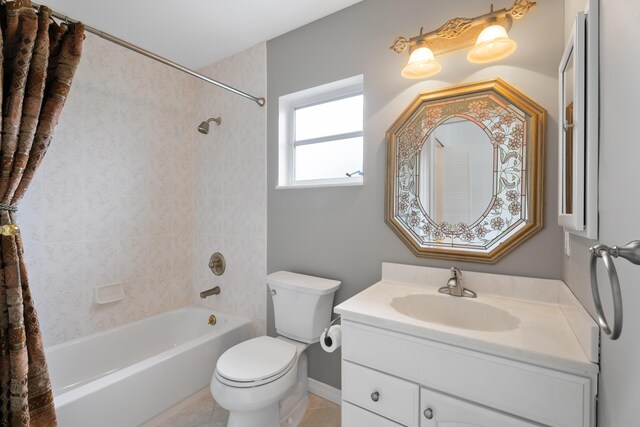 bathroom with tile patterned flooring, toilet, vanity, and  shower combination