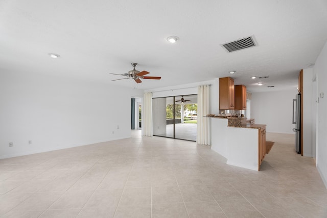 unfurnished living room featuring light tile patterned floors, visible vents, baseboards, and ceiling fan