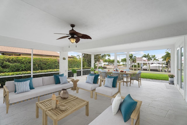 view of patio / terrace featuring outdoor dining space, an outdoor hangout area, and a ceiling fan