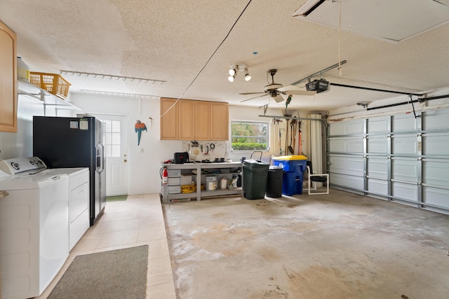 garage with a garage door opener and independent washer and dryer