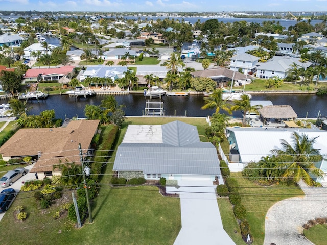 drone / aerial view featuring a residential view and a water view