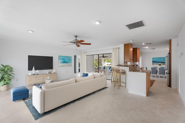 living area with light tile patterned floors, visible vents, ceiling fan, and recessed lighting