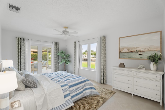 bedroom featuring access to exterior, multiple windows, french doors, and visible vents