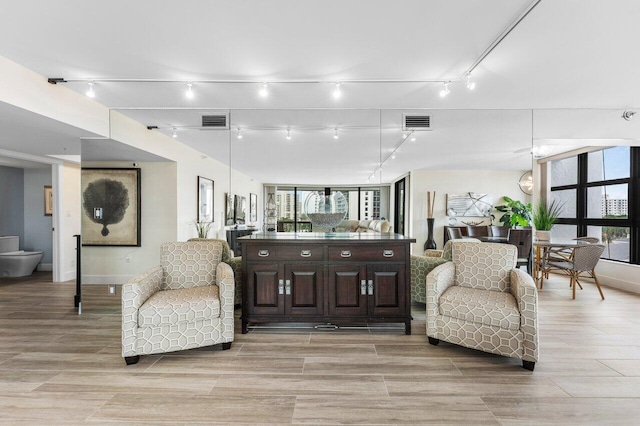 interior space with light wood finished floors and visible vents