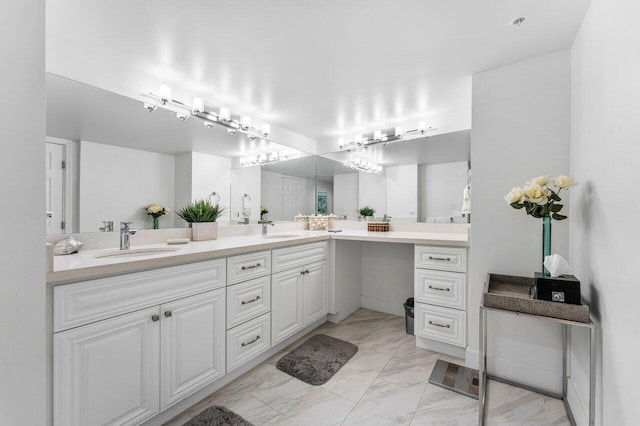 bathroom featuring marble finish floor, double vanity, and a sink