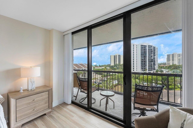 entryway with a wall of windows, a city view, and plenty of natural light