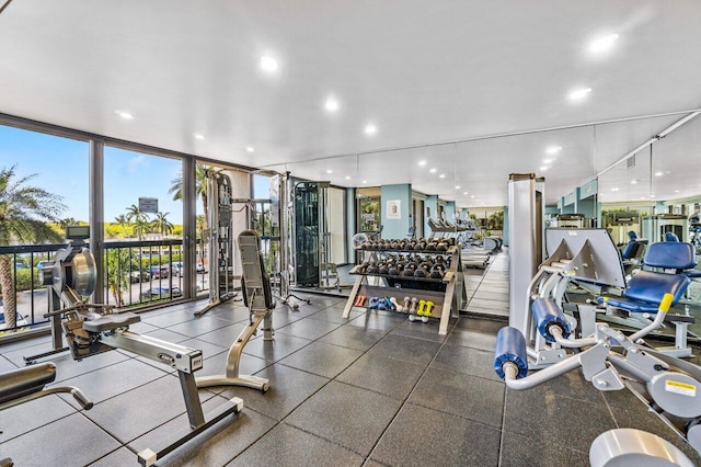 exercise room featuring expansive windows, recessed lighting, and a healthy amount of sunlight