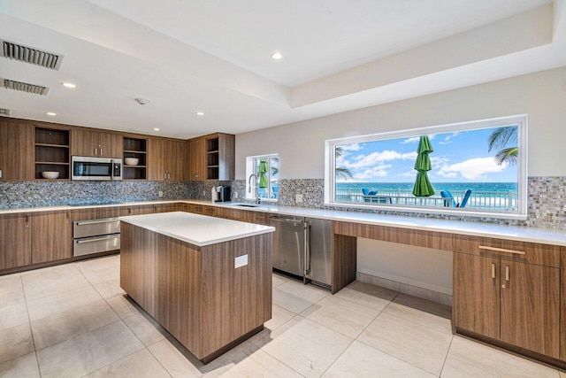 kitchen featuring light tile patterned flooring, stainless steel appliances, visible vents, a warming drawer, and open shelves