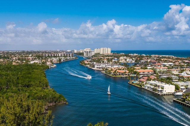 birds eye view of property with a view of city and a water view