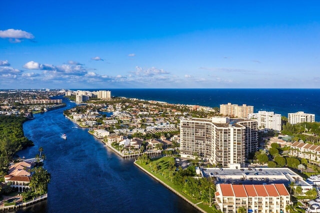 drone / aerial view featuring a view of city and a water view