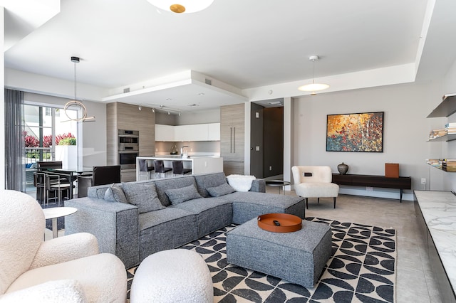 living room with an inviting chandelier and marble finish floor