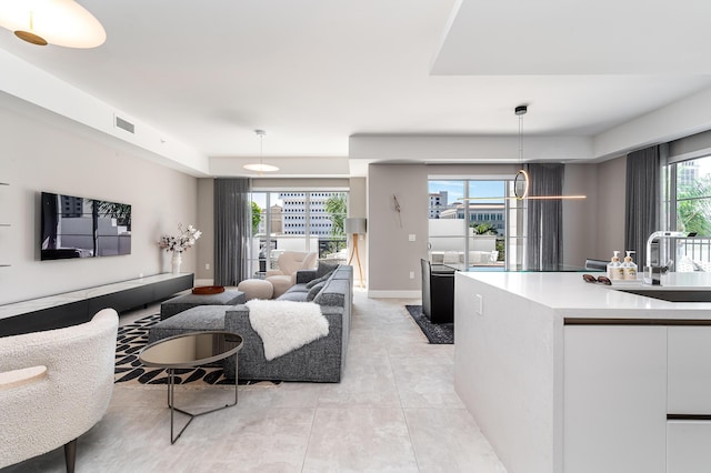 living room featuring visible vents, baseboards, and light tile patterned floors