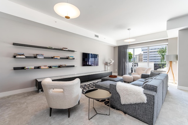 living room with baseboards and visible vents