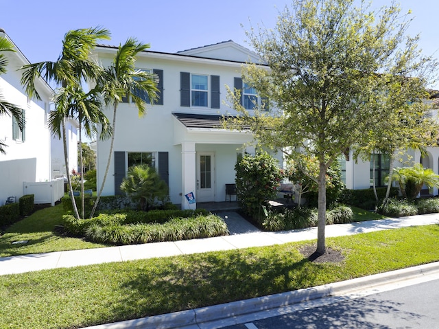 13620 Dumont Rd, Palm Beach Gardens, FL 33418 - view of front of home with a porch, a front yard, and stucco siding