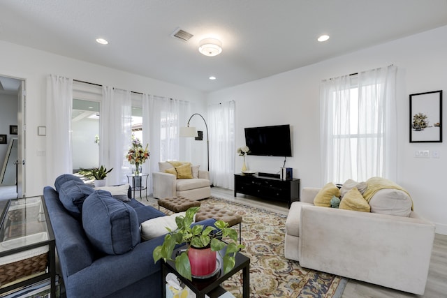 living area featuring wood finished floors, visible vents, and recessed lighting