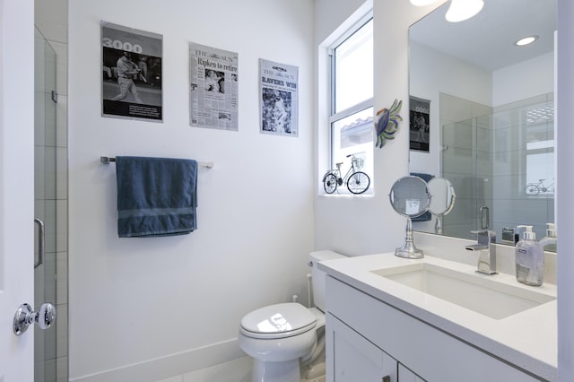 bathroom featuring vanity, a tile shower, and toilet