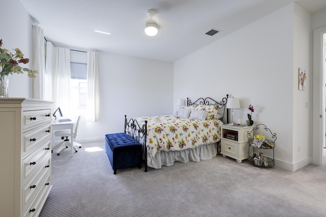 carpeted bedroom with visible vents and baseboards