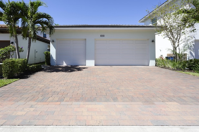 garage featuring decorative driveway