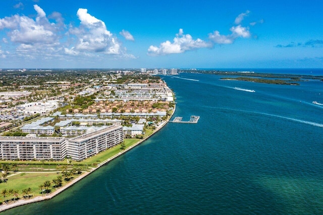 birds eye view of property with a water view and a city view