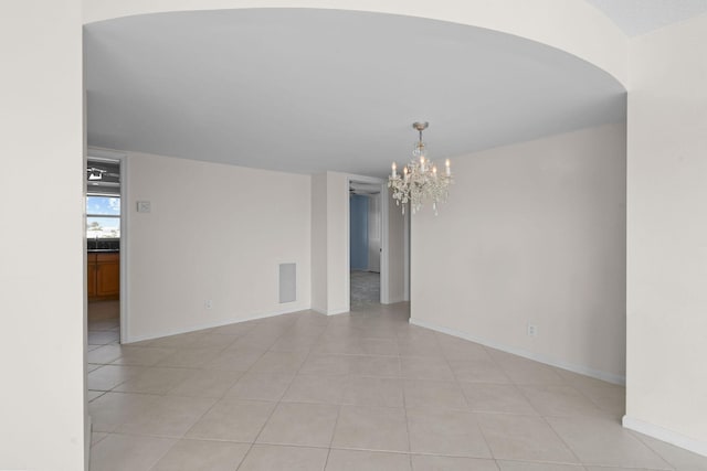 unfurnished room featuring light tile patterned floors, baseboards, a chandelier, and visible vents