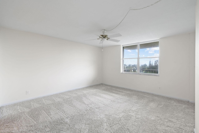 empty room with baseboards, carpet flooring, and ceiling fan