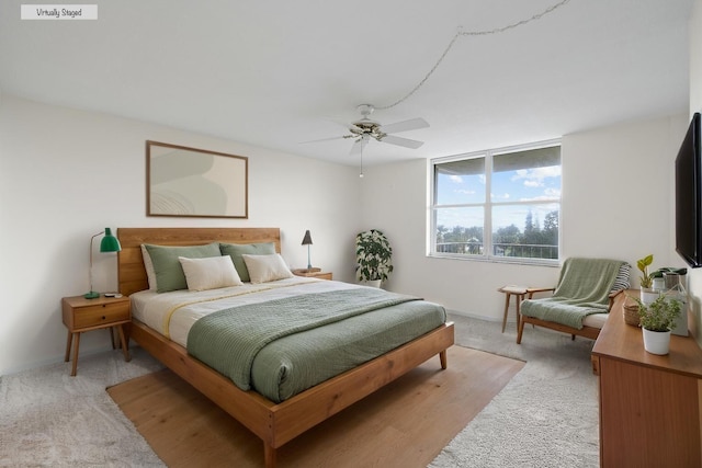 bedroom with ceiling fan and light carpet