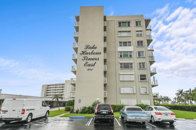 view of building exterior featuring uncovered parking