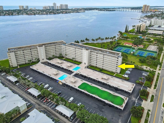 birds eye view of property with a water view and a view of city