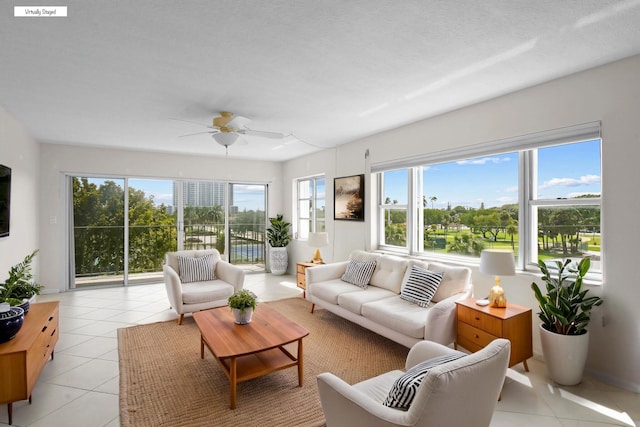 living room featuring light tile patterned floors and a ceiling fan