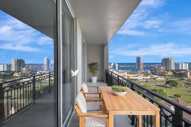 balcony with a water view and a city view