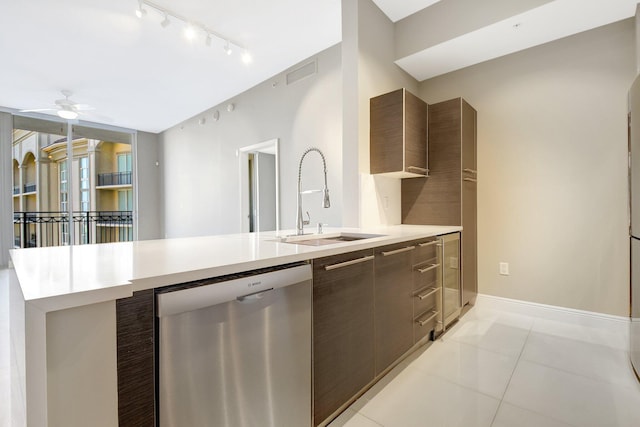 kitchen with visible vents, modern cabinets, light countertops, stainless steel dishwasher, and a sink