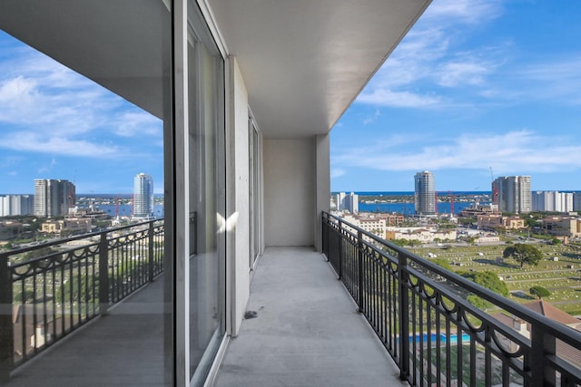 balcony with a water view and a city view