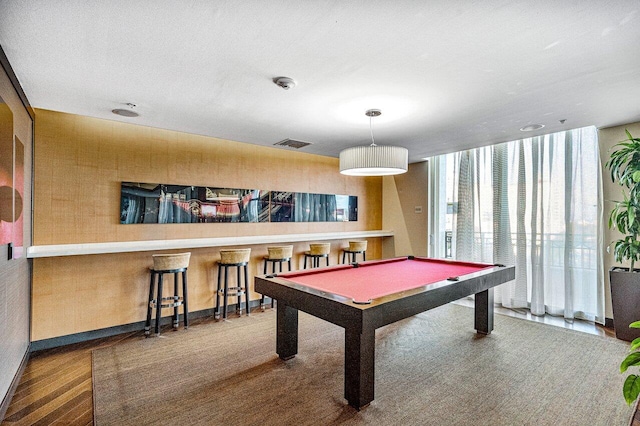 rec room with pool table, wood finished floors, visible vents, baseboards, and floor to ceiling windows