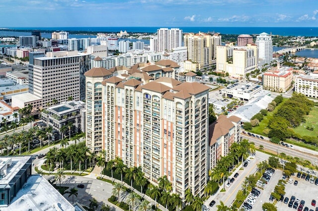 birds eye view of property featuring a water view and a city view