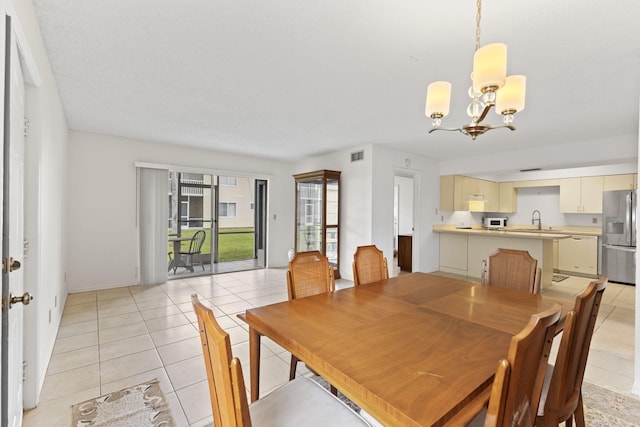 218 SE Village Dr Unit 218, Port Saint Lucie, FL 34952 - dining space with a chandelier and light tile patterned flooring