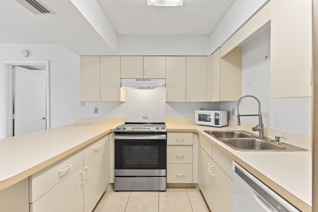 218 SE Village Dr Unit 218, Port Saint Lucie, FL 34952 - kitchen with white appliances, under cabinet range hood, cream cabinets, light countertops, and a sink