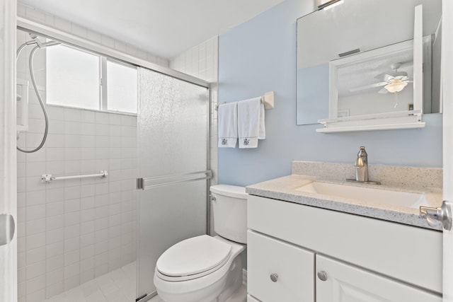 218 SE Village Dr Unit 218, Port Saint Lucie, FL 34952 - bathroom with vanity, a ceiling fan, toilet, and a stall shower