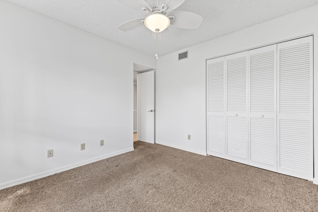 218 SE Village Dr Unit 218, Port Saint Lucie, FL 34952 - unfurnished bedroom with carpet floors, baseboards, a closet, and ceiling fan