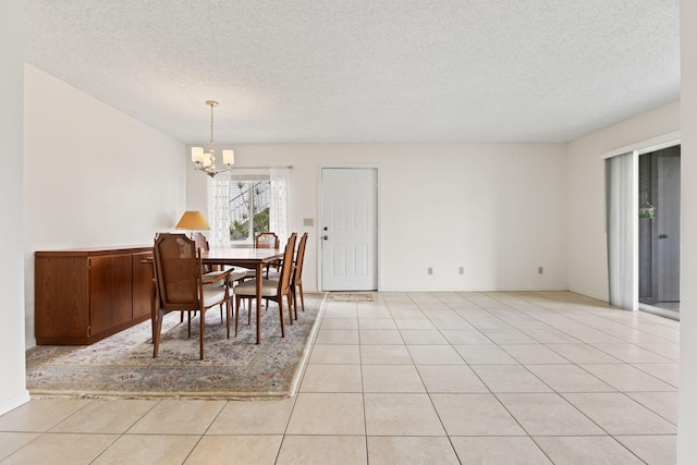 218 SE Village Dr Unit 218, Port Saint Lucie, FL 34952 - dining space with a chandelier, a textured ceiling, and light tile patterned floors