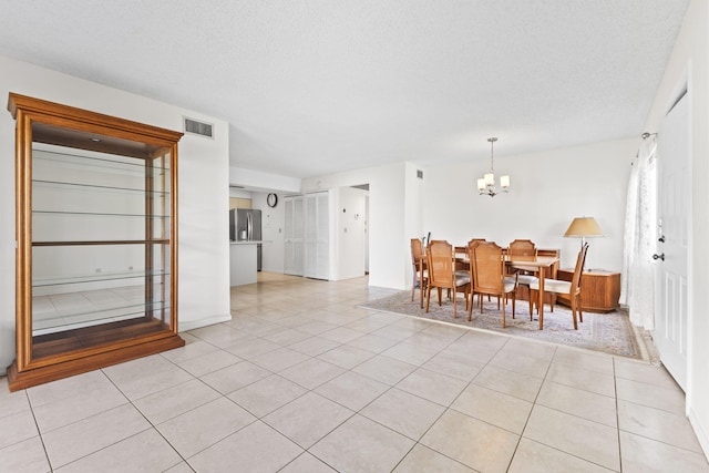 218 SE Village Dr Unit 218, Port Saint Lucie, FL 34952 - dining space with a chandelier and light tile patterned flooring