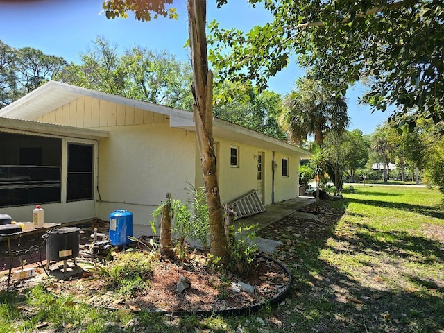 view of property exterior featuring a lawn and stucco siding