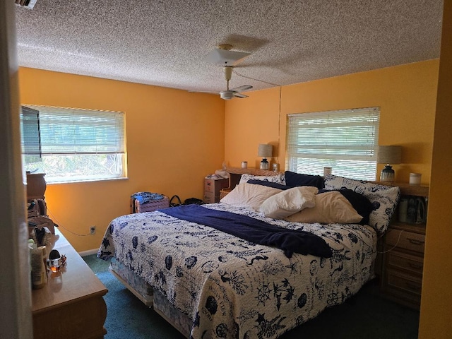 bedroom featuring a ceiling fan, carpet, and a textured ceiling