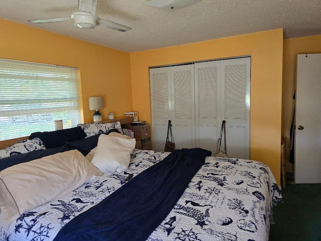 bedroom with a textured ceiling, ceiling fan, and a closet