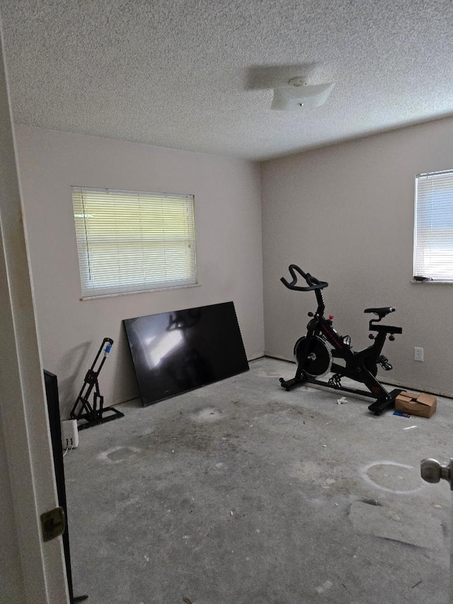 workout area with a textured ceiling