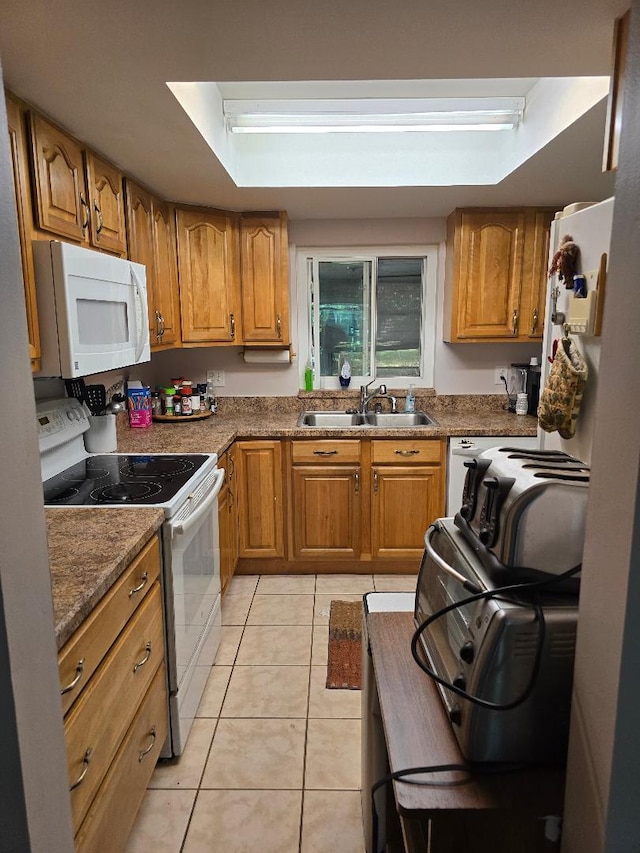 kitchen with brown cabinetry, light tile patterned flooring, electric range oven, and white microwave