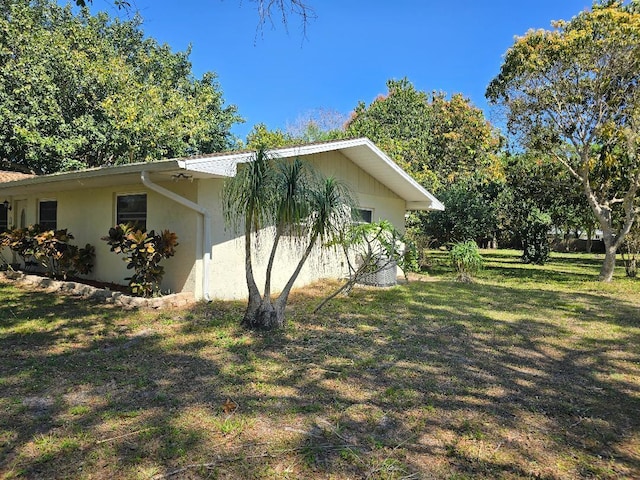 view of home's exterior featuring a lawn and stucco siding